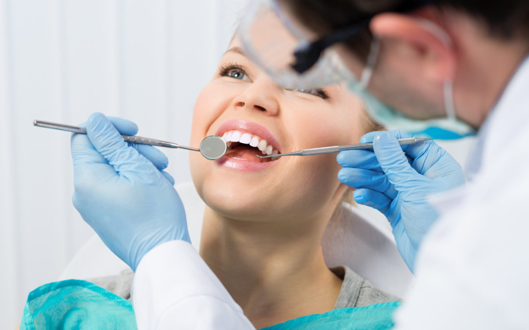 Orthodontist examining patient’s teeth