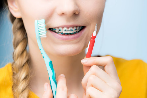 Patient brushing teeth with braces for proper smile care.